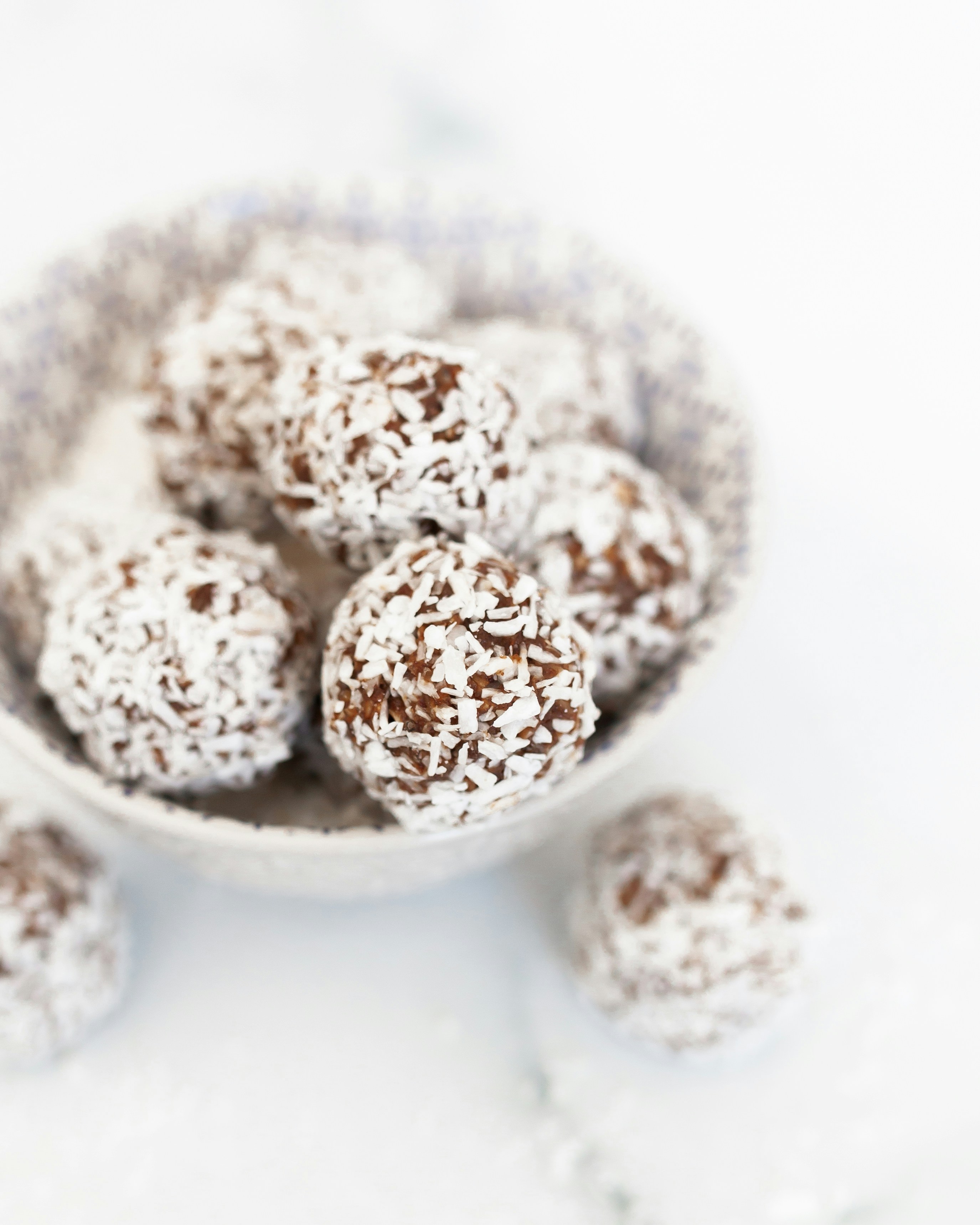 Delicious homemade energy balls arranged in a rustic wooden bowl, perfect healthy afternoon snack